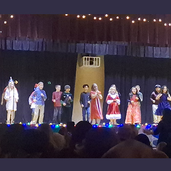 Students singing together on stage