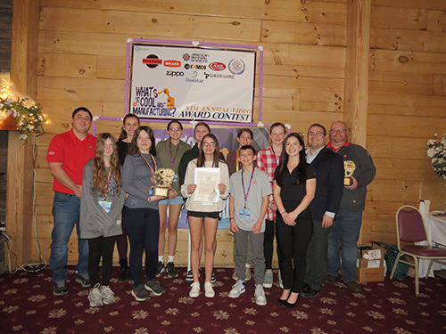 Students on Mrs. Huff's What's so Cool About Manufacturing team holding up awards along with some other adults