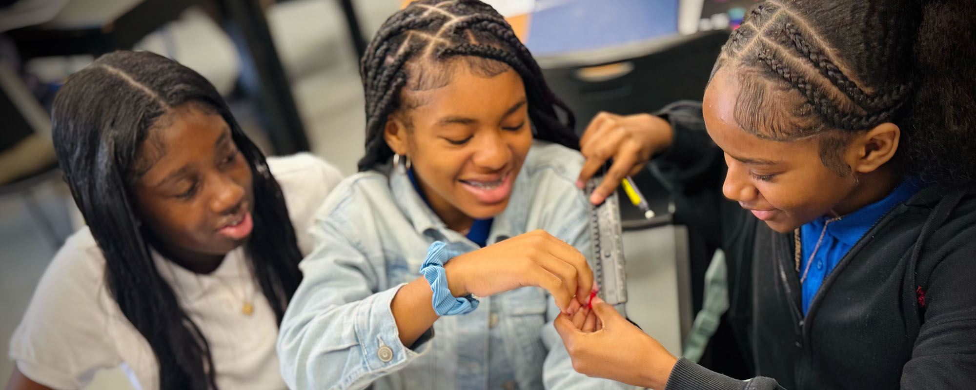 Three girls enjoying working on a project together