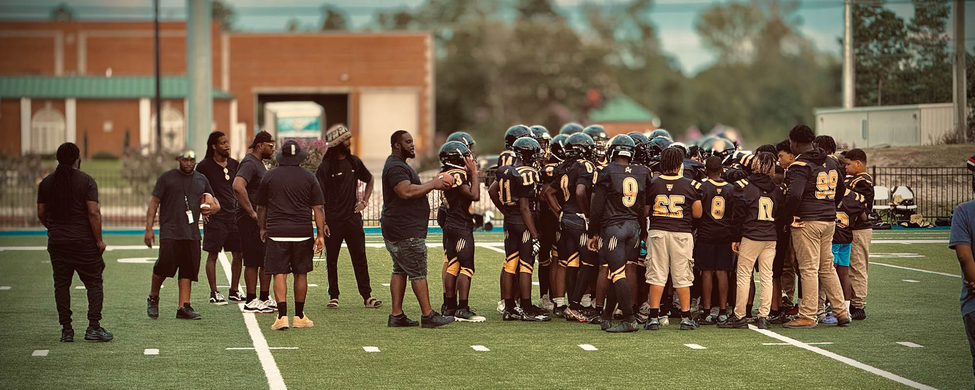 Football players and coaches on the field