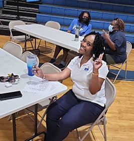 Employee smiling at a table