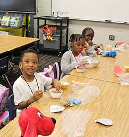 Students eating cereal at a table