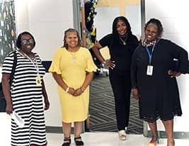 Four happy female staff members posing for a picture