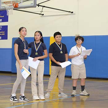 Four students with medals
