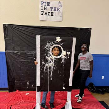 Student playing pie in the face game