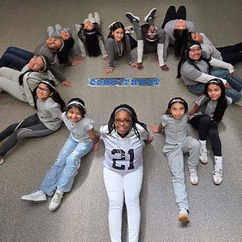 Students sitting in the shape of a heart