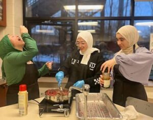 Three students cooking