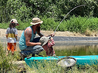 Man and two children fishing